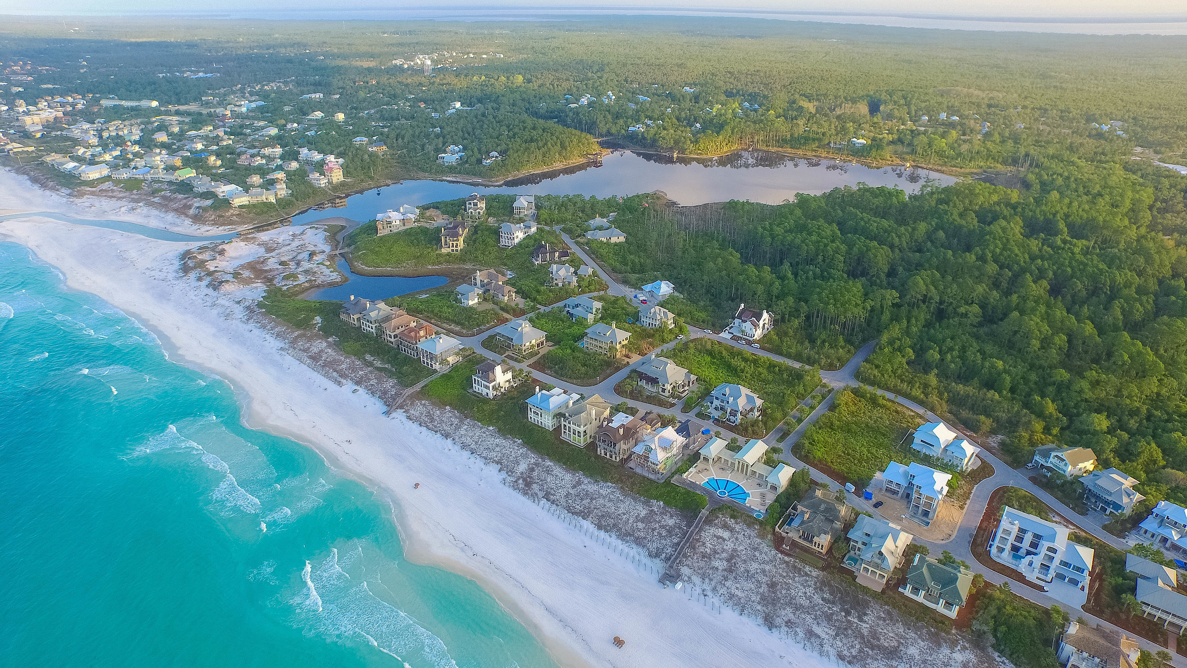 A serene aerial view of The Retreat community with the gulf in the foreground and Draper Lake in the background